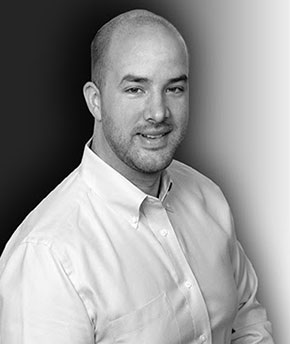 A man in a white shirt with a black and white background