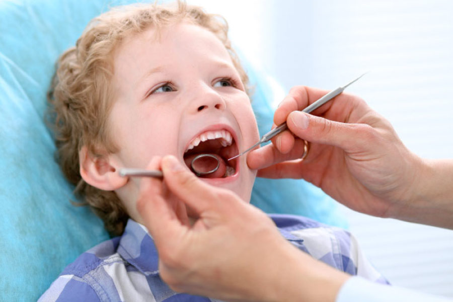 young boy getting a dental exam after overcoming his anxiety