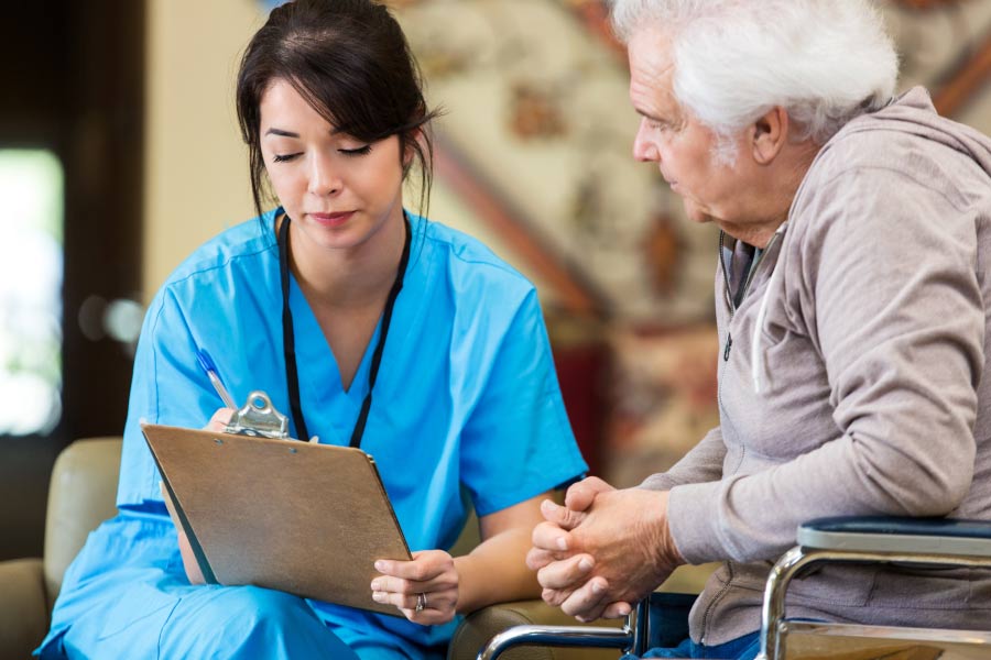 dental technician discusses dental BOTOX treatments with a senior male patient