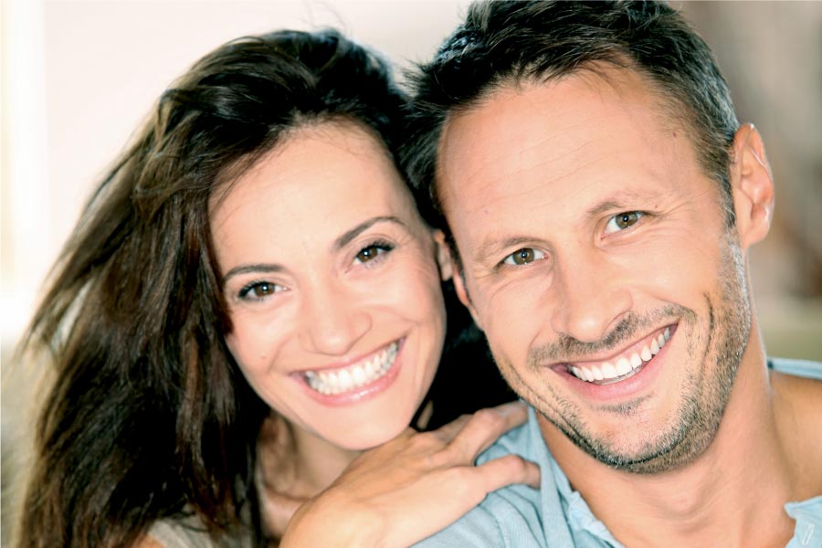 young couple smile showing off their dental veneers