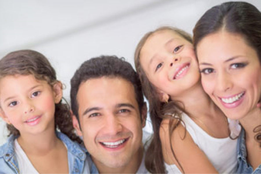 young family of four all smile after finding the right dental office