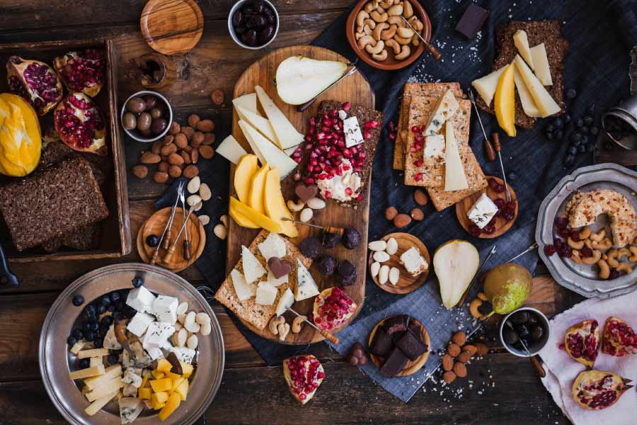 large charcuterie board of cheeses, nuts, fruits, crackers, meats etc.