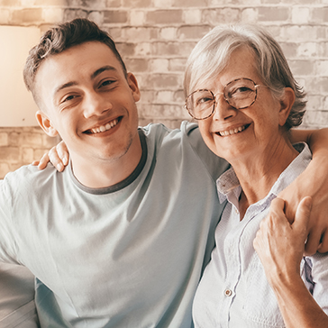 young man hugging his grandmother