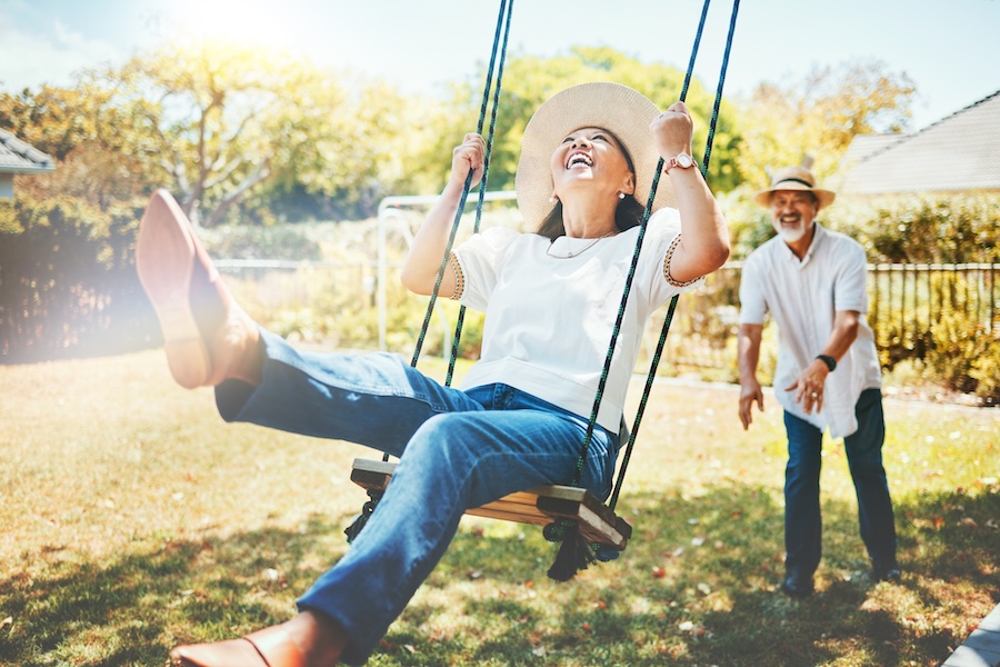 couple on a swing in summer before they visit the dentist